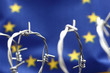 European Union flag and barbed wire, migration to European Union concept