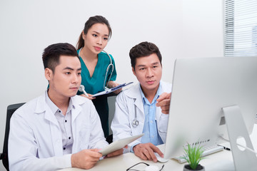 Wall Mural - Young doctors using computer in hospital office