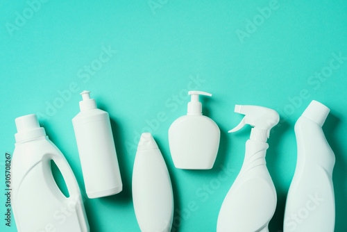 Fotografía Detergent bottles and chemical cleaning supplies on blue background