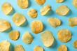 Flat lay composition with potato chips on blue background, top view
