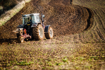 Sticker - farmer plowing his fields in autumn