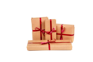 Gift Boxes in Craft Wrapping Paper with Red Ribbons isolated