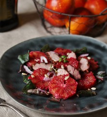 Wall Mural - salad with red Sicilian orange (blood orange), duck breast, beet top (chard), sunflower seeds, red onion. gourmet recipe, winter salad