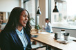 © Flamingo Images - Laughing young African American businesswoman walking through an
