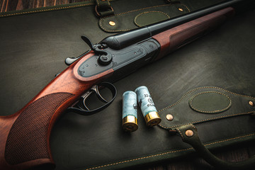 Poster - Classic trigger double-barreled hunting rifle on a green background. Smooth-bore hunting rifle open for reloading. Concept postcards for hunters.