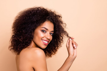 Wall Mural - Close up side profile photo beautiful she her dark skin lady fluffy hairstyle hairdo play ideal curl salon spa procedure aesthetic pure perfect appearance wear nothing isolated pastel beige background