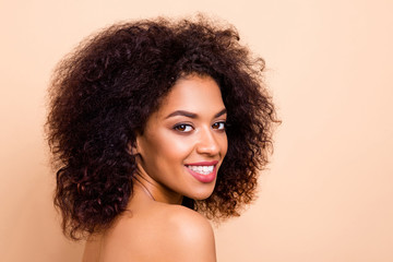 Wall Mural - Close up side profile photo beautiful she her dark skin lady fluffy hairstyle hairdo refreshed salon spa procedures aesthetic pure perfect appearance wear nothing isolated pastel beige background