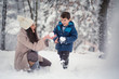 © stivog - Young, beautiful mom and her cute little boy playing in the snow, enjoying winter