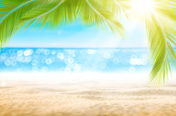 Wall Mural - blur beautiful nature green palm leaf on tropical beach with bokeh sun light wave abstract backgroun