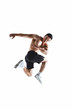 © alesgon - Muscle male model in black sports shorts and white sneakers in a jumping pose on white background. Sports motion concept. Studio shot.