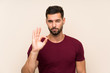 © luismolinero - Handsome man over isolated background showing an ok sign with fingers