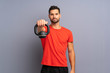 © luismolinero - Young sport man making kettlebell