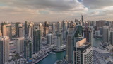 Fototapeta  - Dubai Marina skyscrapers and jumeirah lake towers view from the top aerial timelapse in the United Arab Emirates.