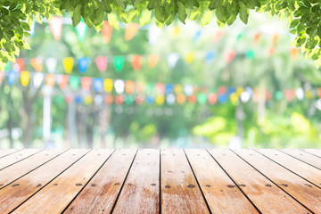 Wall Mural - Empty wooden table with party in garden background blurred.