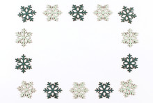  Christmas Frame Made Of Blue Wooden Snowflakes On A White Background Copy Space