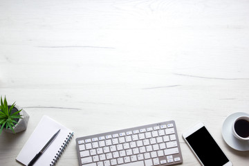 White desk office with laptop, smartphone and other work supplies with cup of coffee. Top view with copy space for input the text. Designer workspace on desk table essential elements on flat lay