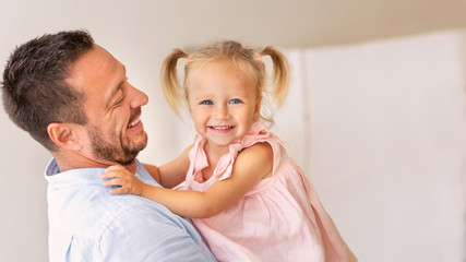 Loving father with daughter looking at camera