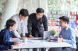 © amnaj - Group of young asian business people working and brainstorming and exchanging ideas at the meeting.