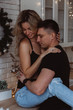 © dimadasha - Romantic christmas evening of a young couple. New year love story. Photo session of lovers in the kitchen.