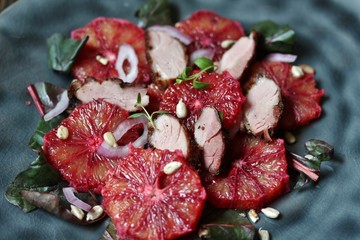 Poster - salad with red orange (blood orange), duck breast, beet top (chard), sunflower seeds, red onion. gourmet recipe, winter salad