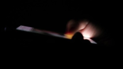 Wall Mural - Female thumbs touching and moving a smartphone screen with Facebook images