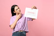 © New Africa - Pensive young woman holding calendar with marked menstrual cycle days on pink background