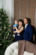 © combo1982 - Beautiful happy family of three on New Year's Eve. Christmas meeting 2020.