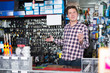 © JackF - worker in hardware store trading goods and keys in uniform