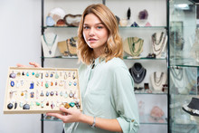 Saleswoman Showing Pendants From Natural Gemstones
