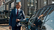 © Svitlana - I need to be there in time. Handsome and confident mature man in classic suit adjusting his jacket and looking away while standing outdoors near his black car