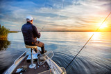 fisherman in a boat on the lake in autumn