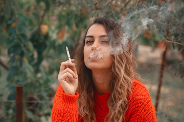 beautiful woman smokes a cigarette