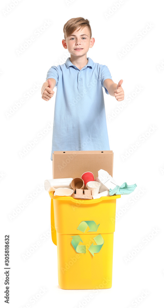 Little boy showing thumb-up near container with trash on white background. Concept of recycling