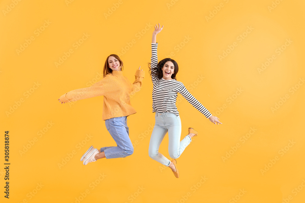 Jumping women on color background
