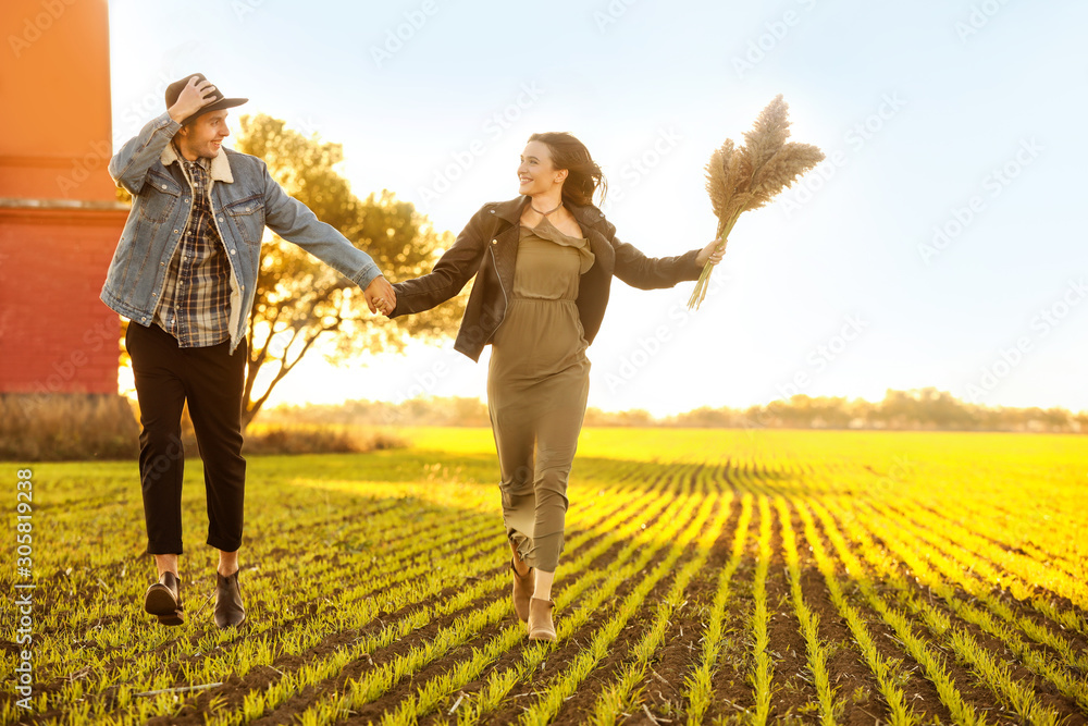 Happy young couple running in countryside