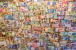 © mauro53 - An  assortment money currencies stuck on a wall