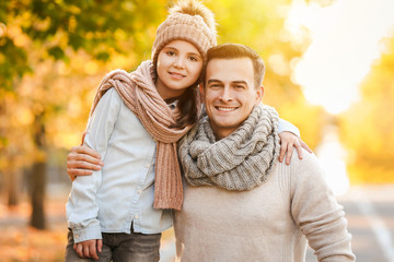 Canvas Print - Portrait of happy father and little daughter in autumn park