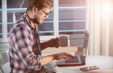 social media influencer and marketing. blogger working on laptop adding   a new content to profile. smm and e-business advertising concept