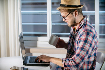 social media influencer and marketing. blogger working on laptop adding a new content to profile. sm
