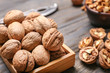 © Pixel-Shot - Box with tasty walnuts on wooden background