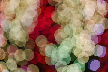Wall Mural - Gold, red and purple Christmas light shiny abstract round bokeh on dark background. Colourful Glitter bokeh from blurry decoration bulbs.