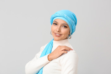 Poster - Portrait of beautiful Muslim woman on light background