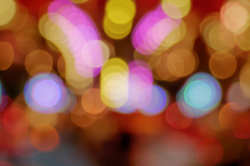 Wall Mural - Golden and red Christmas light shiny abstract round bokeh on defocused background of celebration. Colourful Glitter bokeh from blurry decoration bulbs.