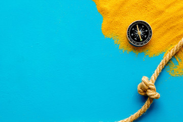 Wall Mural - Goal achievement concept. Compass near rope with knot on blue background top view copy space