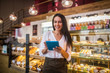 © zinkevych - Cheerful young businesswoman ordering foods for her bakery
