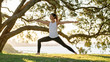 © Josh - Young woman doing yoga under tree in park