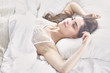 © lenetsnikolai - beautiful young woman basking in bed in the morning. Beautiful