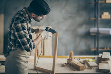 Profile Side Photo Of Serious Concentrated Worker Man Use Electric Hot Glue Gun To Repair Wooden Construction Frame Work In Home House Garage