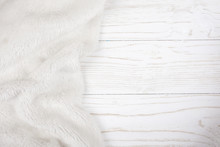 White Fur On A Worn White Wooden Background (top View, Copy Space On The Right), Selective Focus