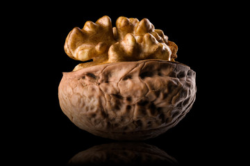 Wall Mural - Half opened walnut with kernel isolated on a black background with clipping path